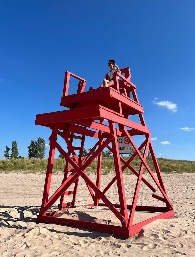 Kaylee on a giant red lifeguard chair