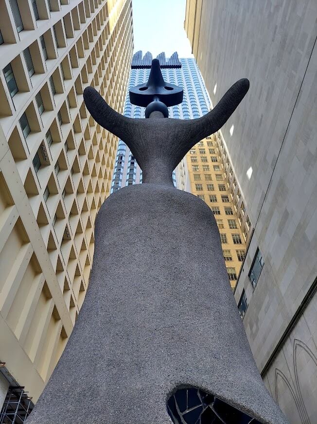 concrete and steel sculpture of bird lady