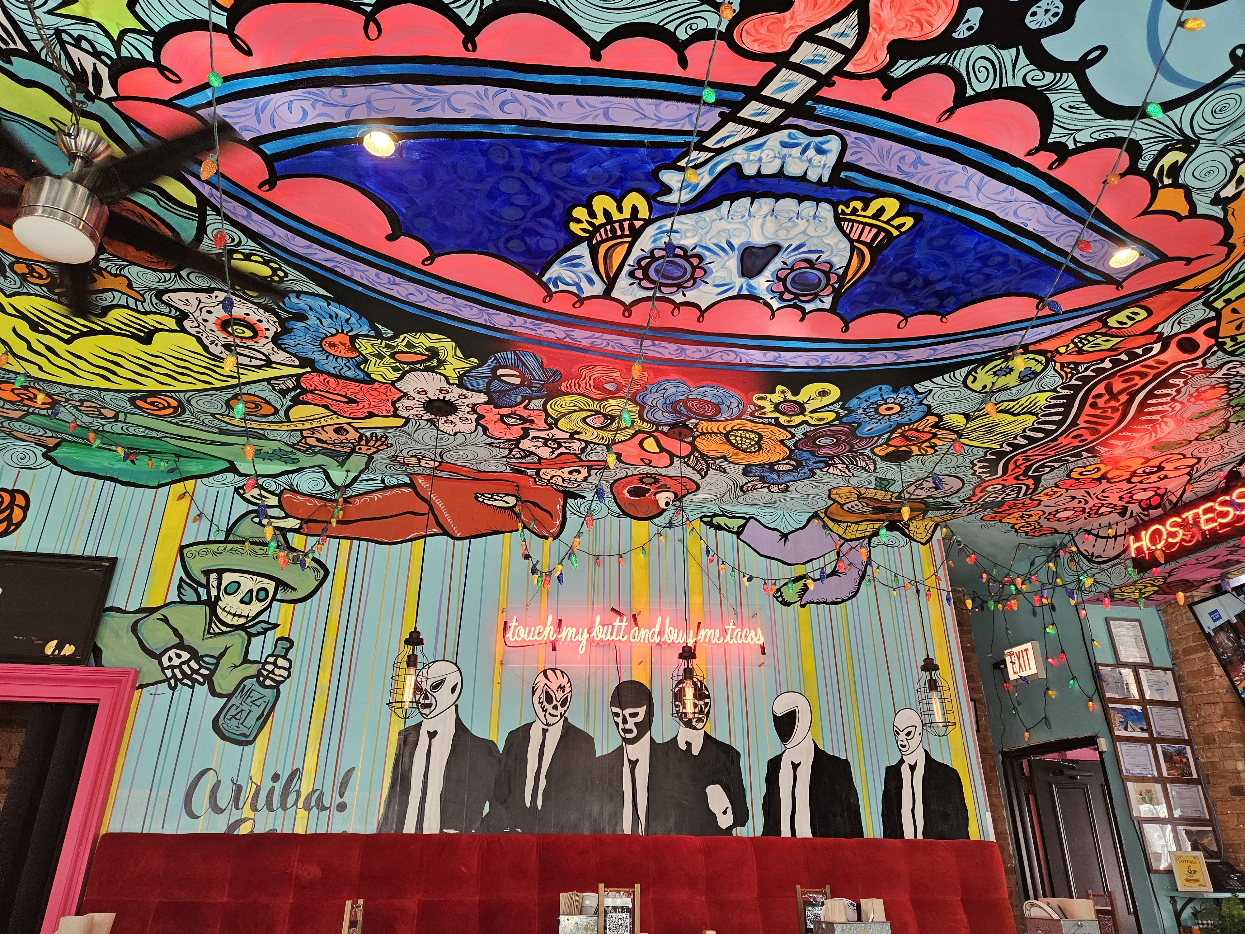 bright mexican skull and flower mural on ceiling
