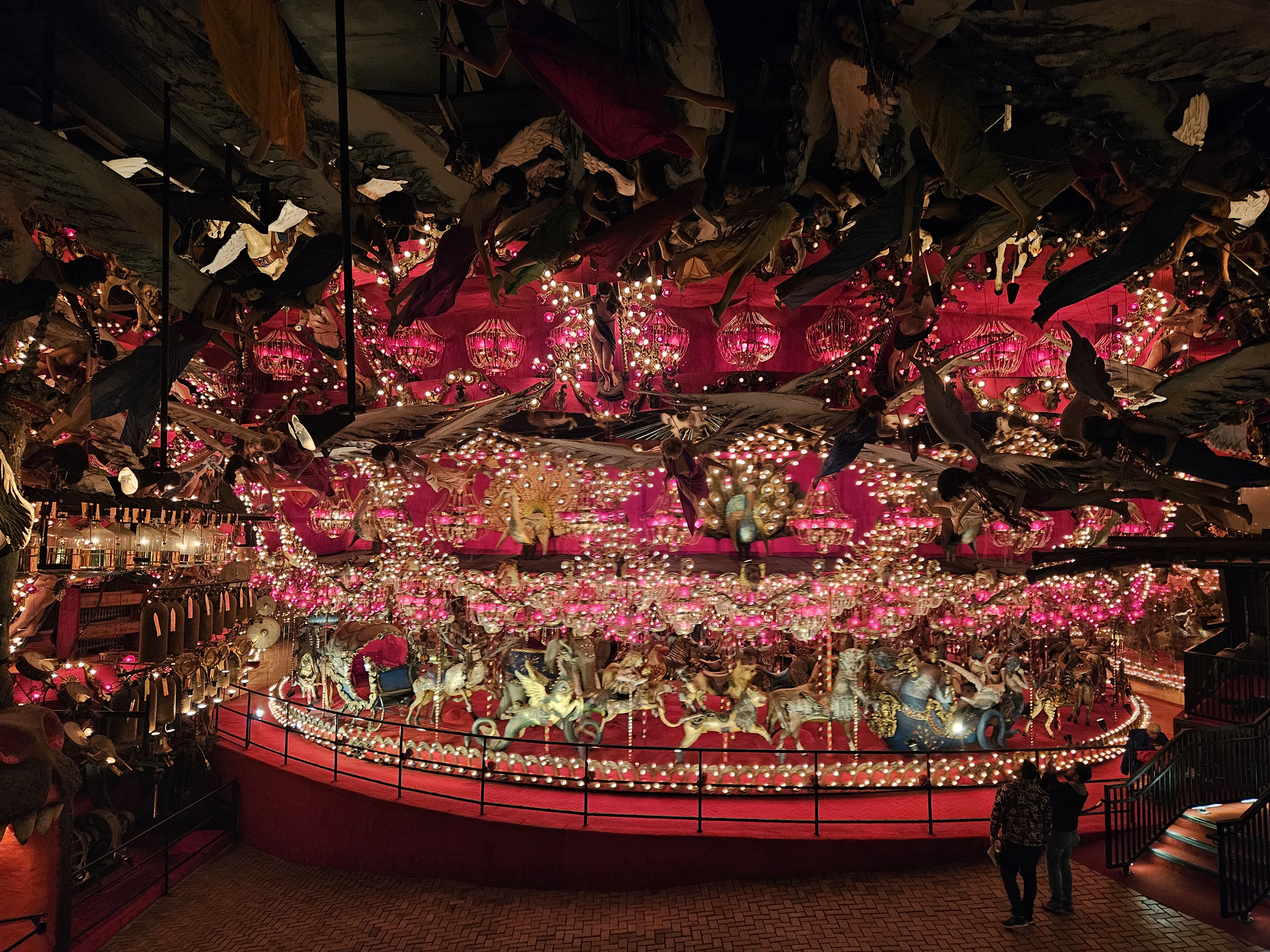 red and gold chandelier with mechanical violin players