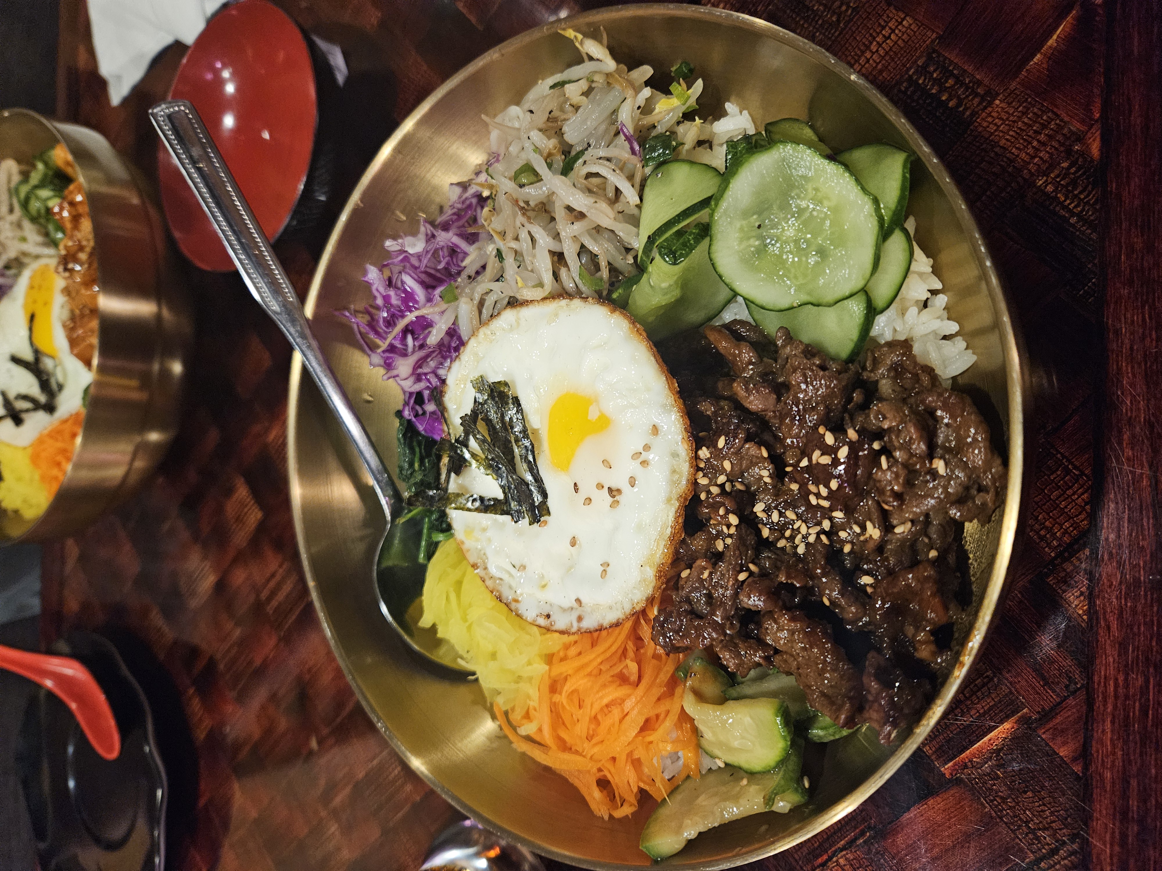 fried egg, bolgogi, veggies in gold bowl
