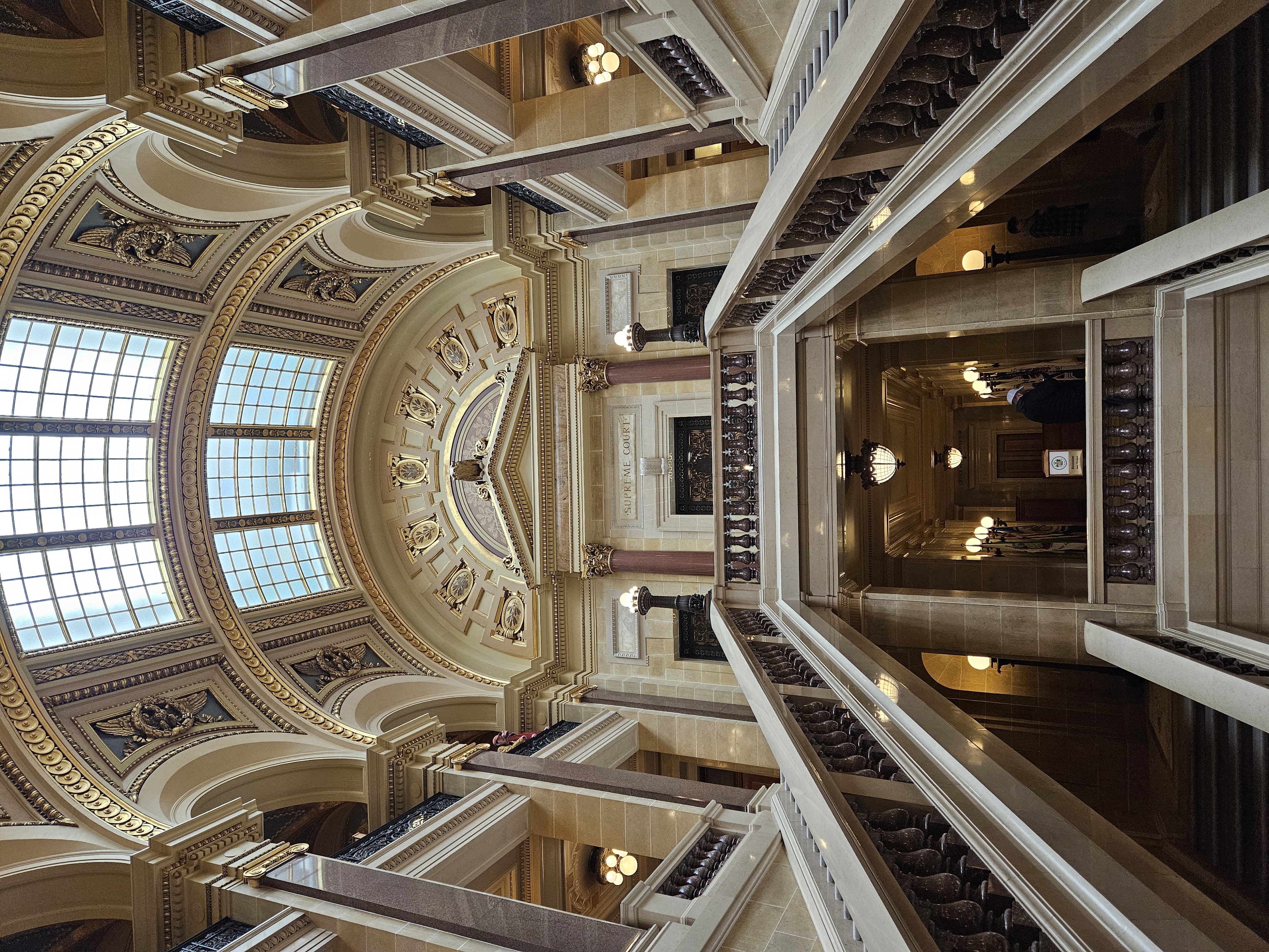 dark stone stairs and marble handrails under skylight