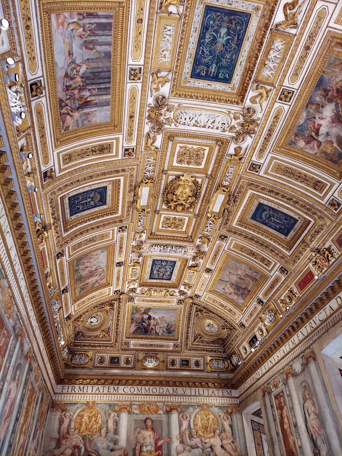 paintings in gold frames on ceiling