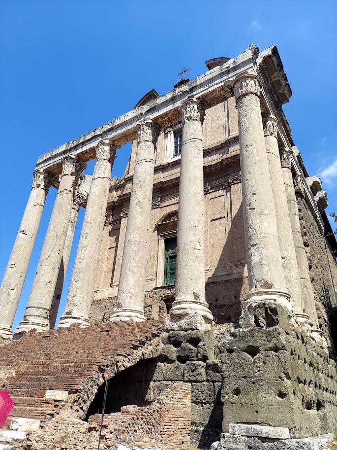 outside greek buildings and white columns