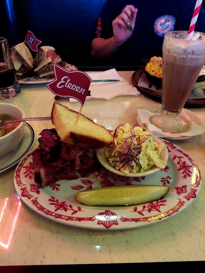 plate of corned beef sandwich with a flag in it