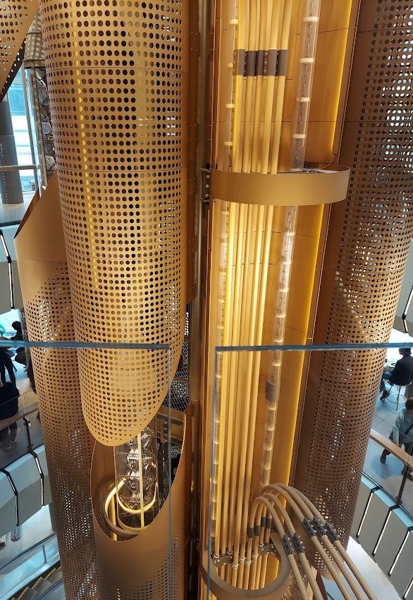 large golden tubes running up five floors