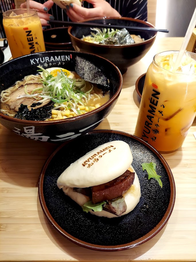 ramen, a bao bun, and jar of thai tea