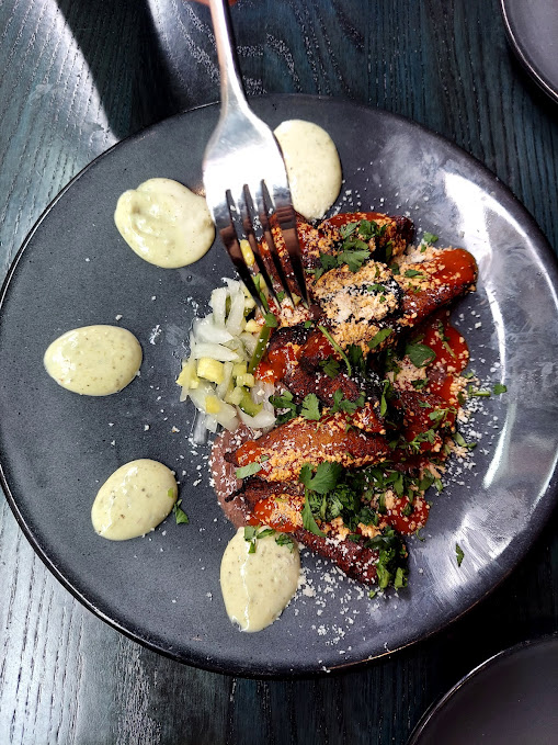 row of plantains and dollops of sauce