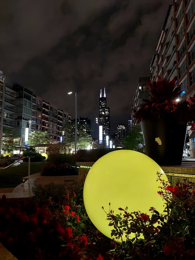 yellow light orb in front of night chicago skyline