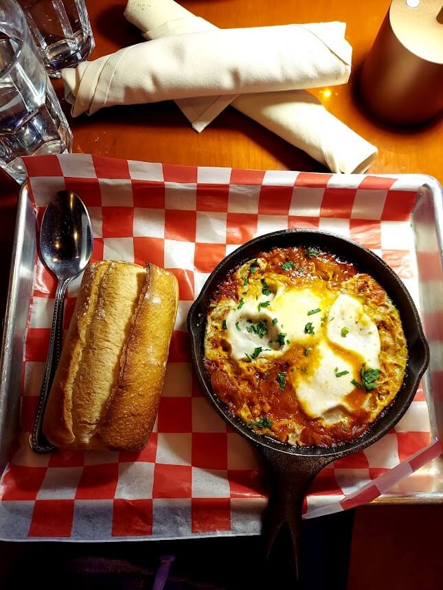 cast iron skillet of shakshuka and bread