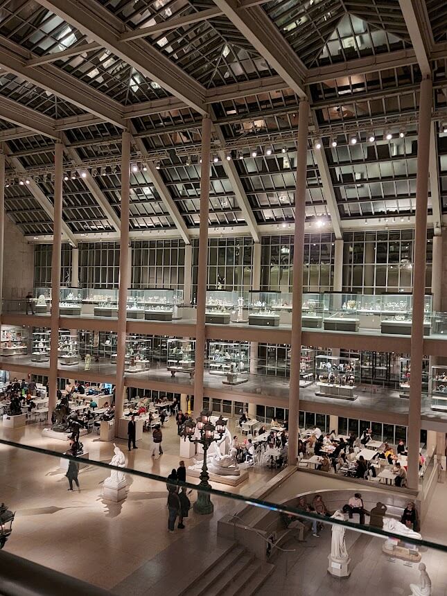 indoor balcony with sculptures and a cafe