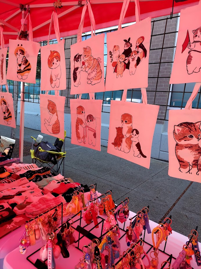 collection of tote bags of round eyed cats