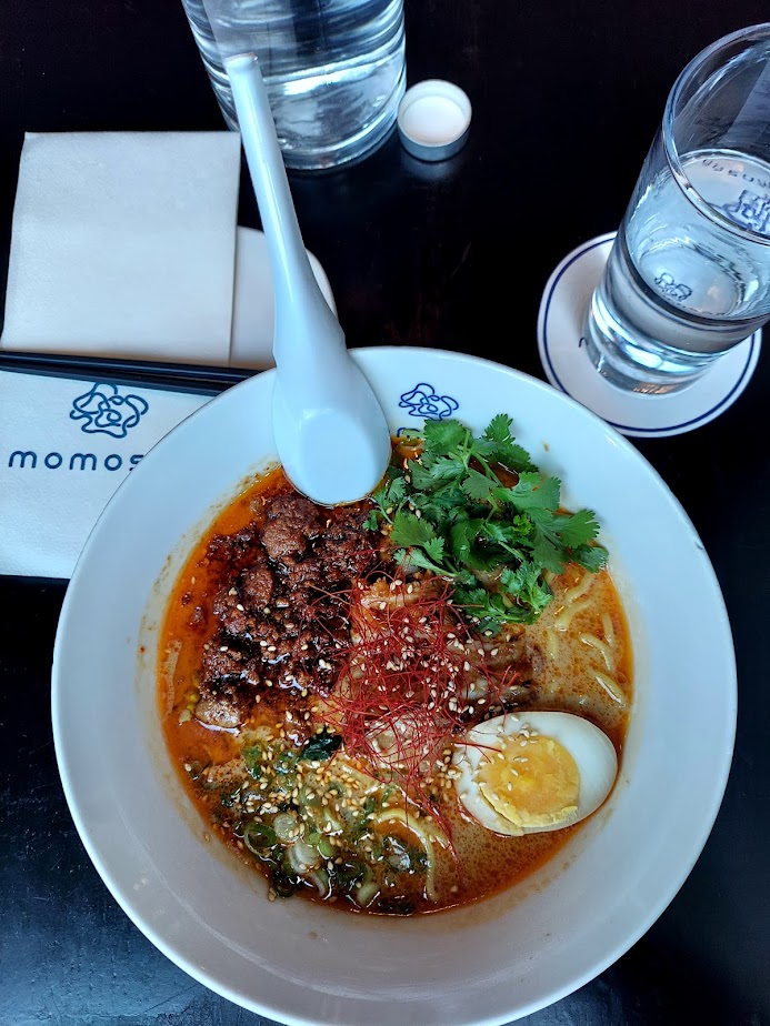 ramen in a white bowl with ground pork