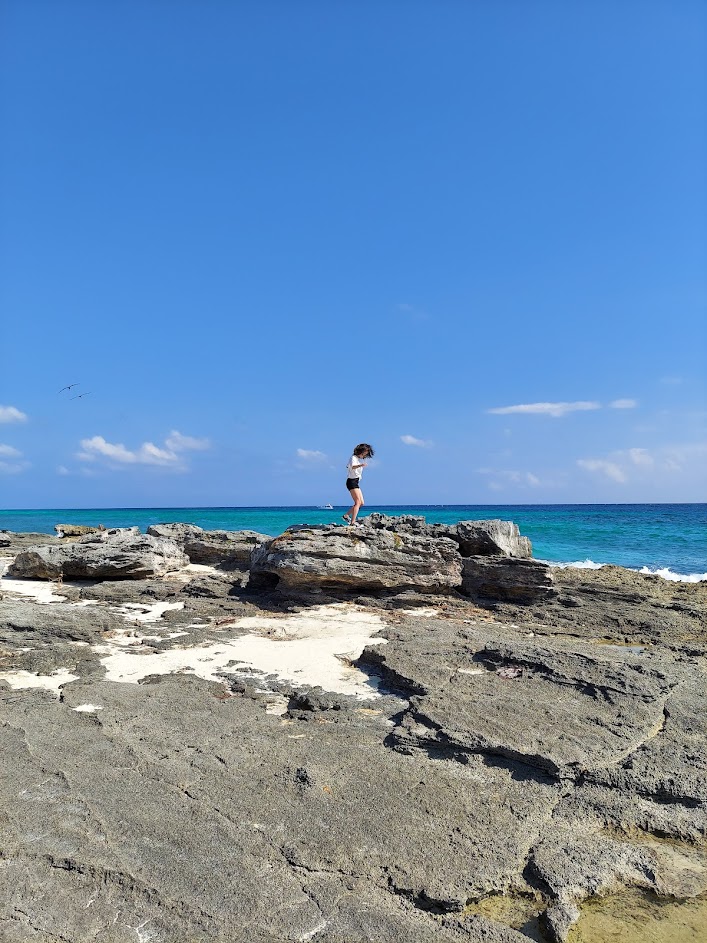 me on a rock along the blue ocean